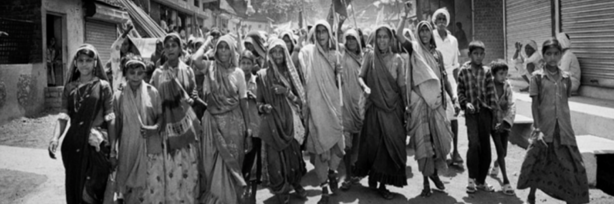 Group of Indian protesters walking down a street