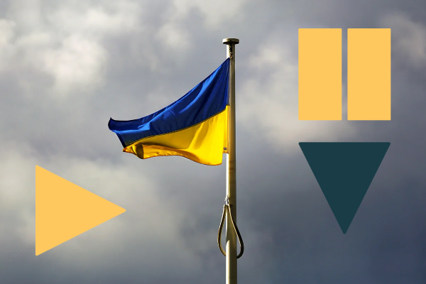 Photo of the Ukraine flag (blue on top yellow on bottom) against a cloudy sky.